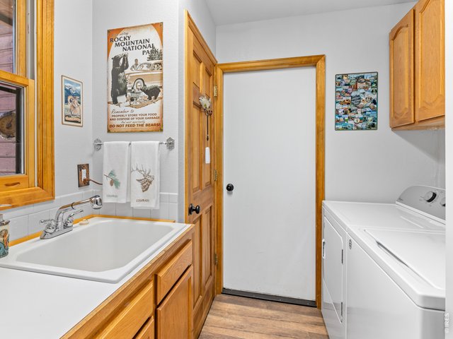 Property Photo 35 main level laundry room with large sink, exit to garage