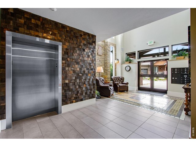 Property Photo 6 Welcome! Secure Main Lobby entrance. Gorgeous finishes grace the interior, chunky baseboards, large format tile work and walnut accents! 