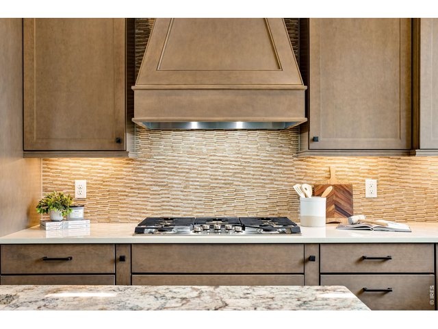 Property Photo 16 Exterior vented hood, 5 burner gas cooktop and beautifully crafted Wellborn cabinetry, soft close with dove tail joints. 