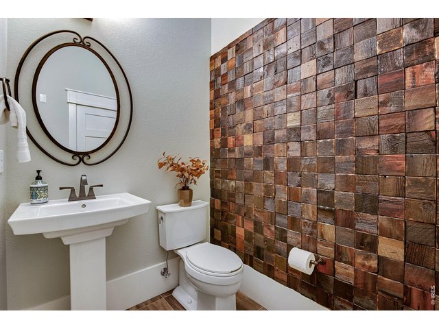 Property Photo 10 Striking Walnut accent wall in the powder bathroom, all comfortable height toilets.
