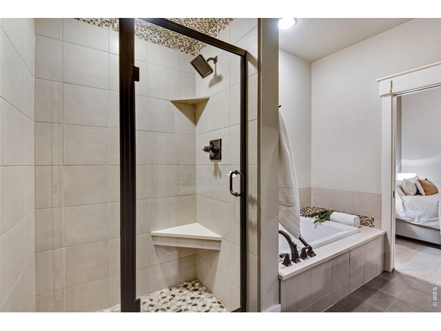 Property Photo 44 Full 5 piece bathrooms with stunning tile work and poured pan shower floors! 