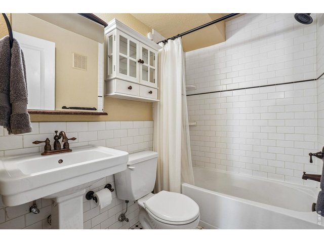 Property Photo 12 Full Bath with White Subway Tile Finish