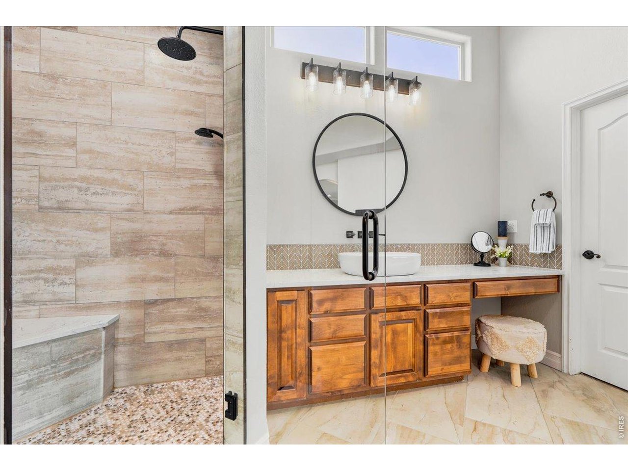 Fully tiled enclosed steam shower and second vanity/makeup station
