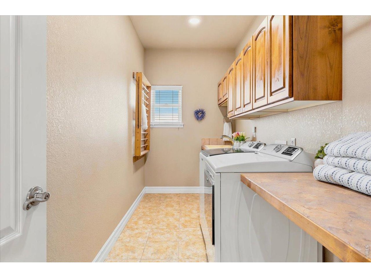 Large 2nd floor laundry with laundry sink and folding counter