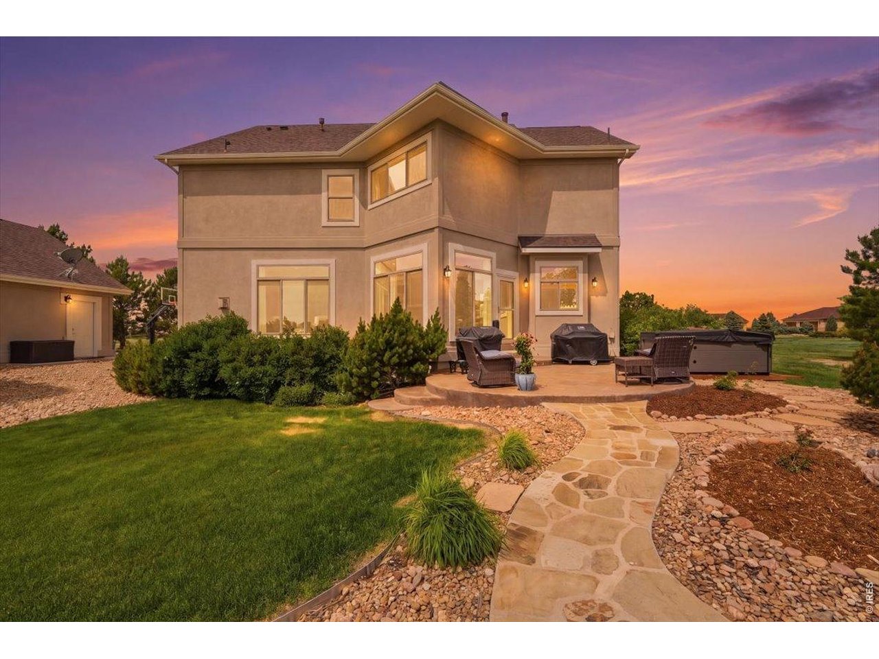Two tiered patio with pristine landscaping