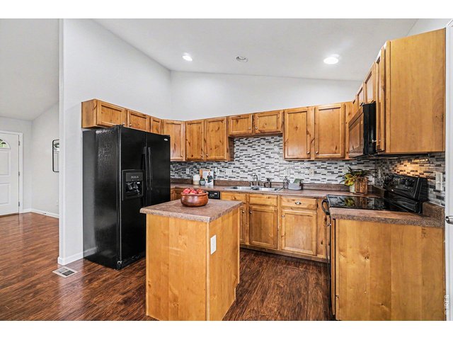 Property Photo 10 Cheerful kitchen with warm finishes, great prep space
