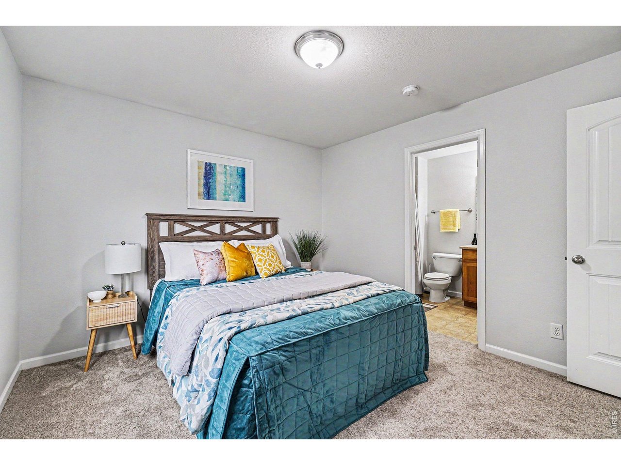 Comfortable primary retreat with an attached private bathroom and walk in closet 