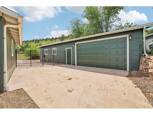 Property Photo 5 Oversized garage/workshop has underfloor PVC piping for dust collection. The 240 is ideal for a wood shop and or a vehicle lift. Plumbed for a bathroom.