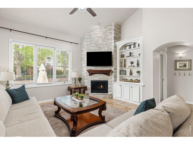 Property Photo 12 Custom Stone Fireplace With Mantle and Built In Cabinetry