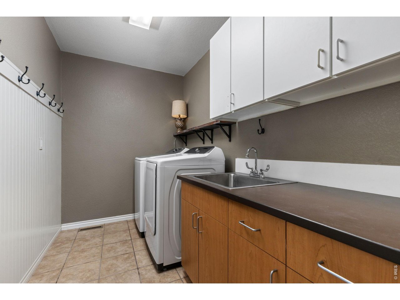 Large Main Floor Laundry Room with Sink, Counter and Cabinets