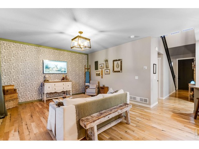 Property Photo 18 Family room features a custom light fixture and cozy French country accent wall