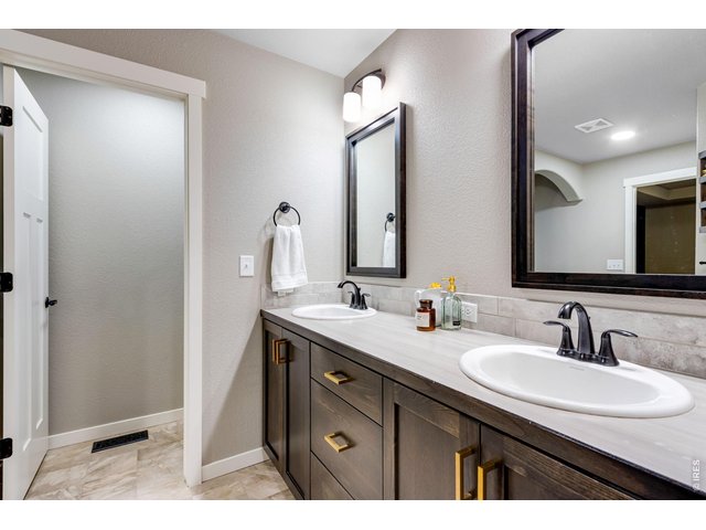 Property Photo 25 5-piece luxury bath with 2 lifted vanities, upgraded mirrors and light fixtures plus a door to throne