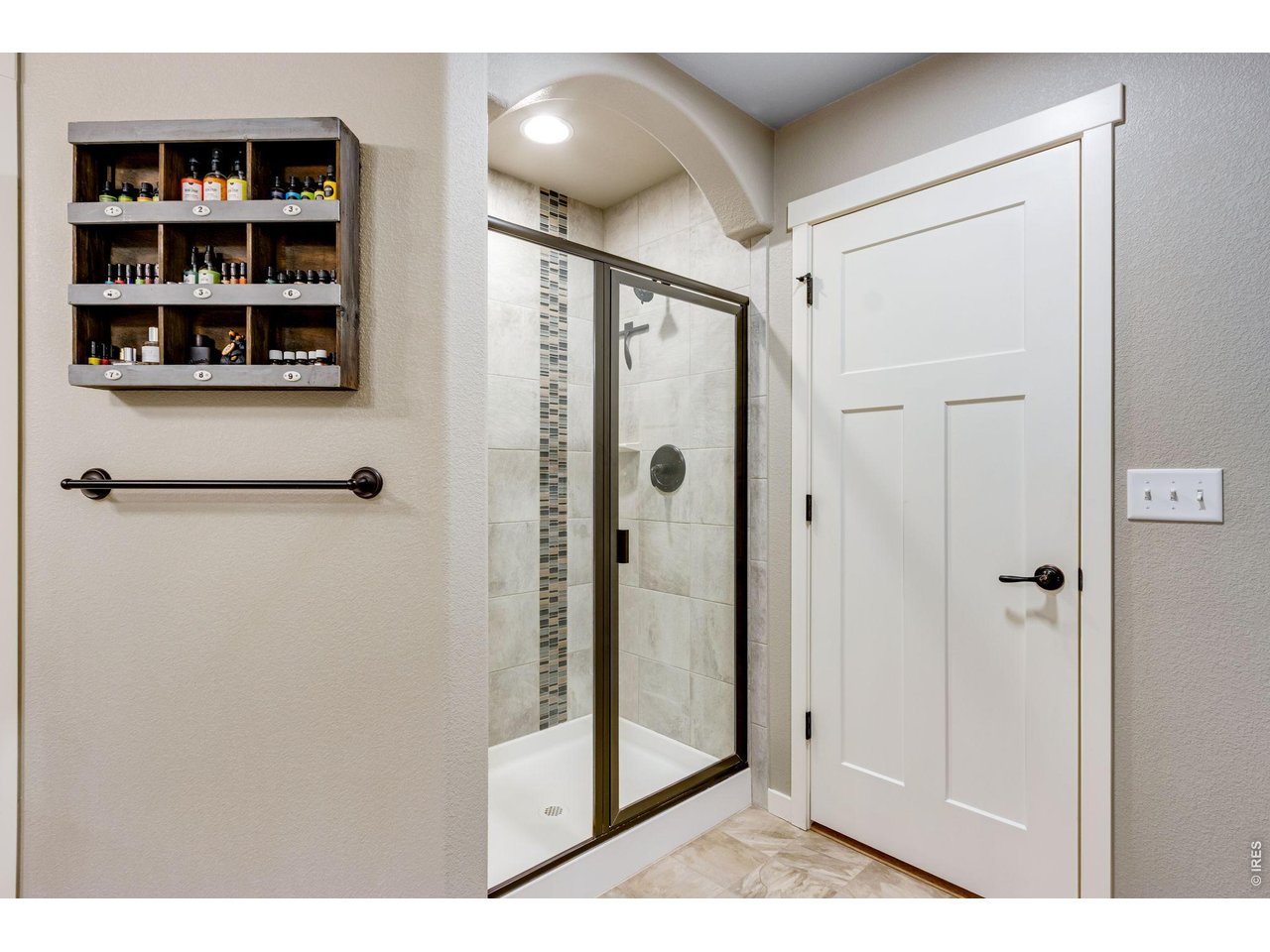 Primary bedroom shower with floor to ceiling tile 