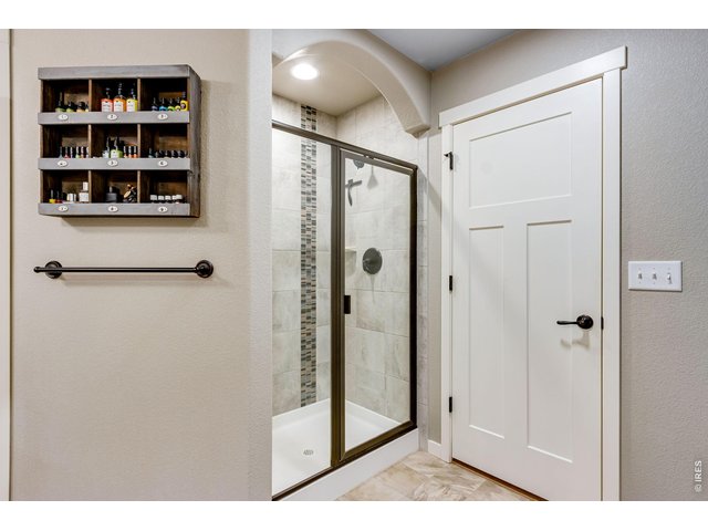 Property Photo 27 Primary bedroom shower with floor to ceiling tile 