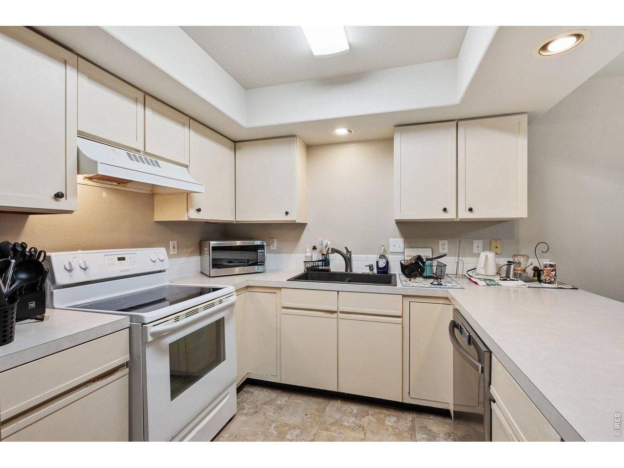 Kitchen has painted cabinets, new dishwasher, and extra pantry space