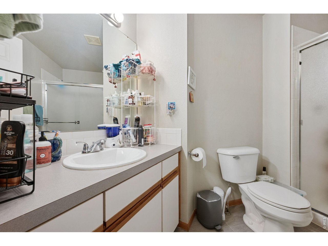 Ensuite primary bath with walk-in shower and newer flooring