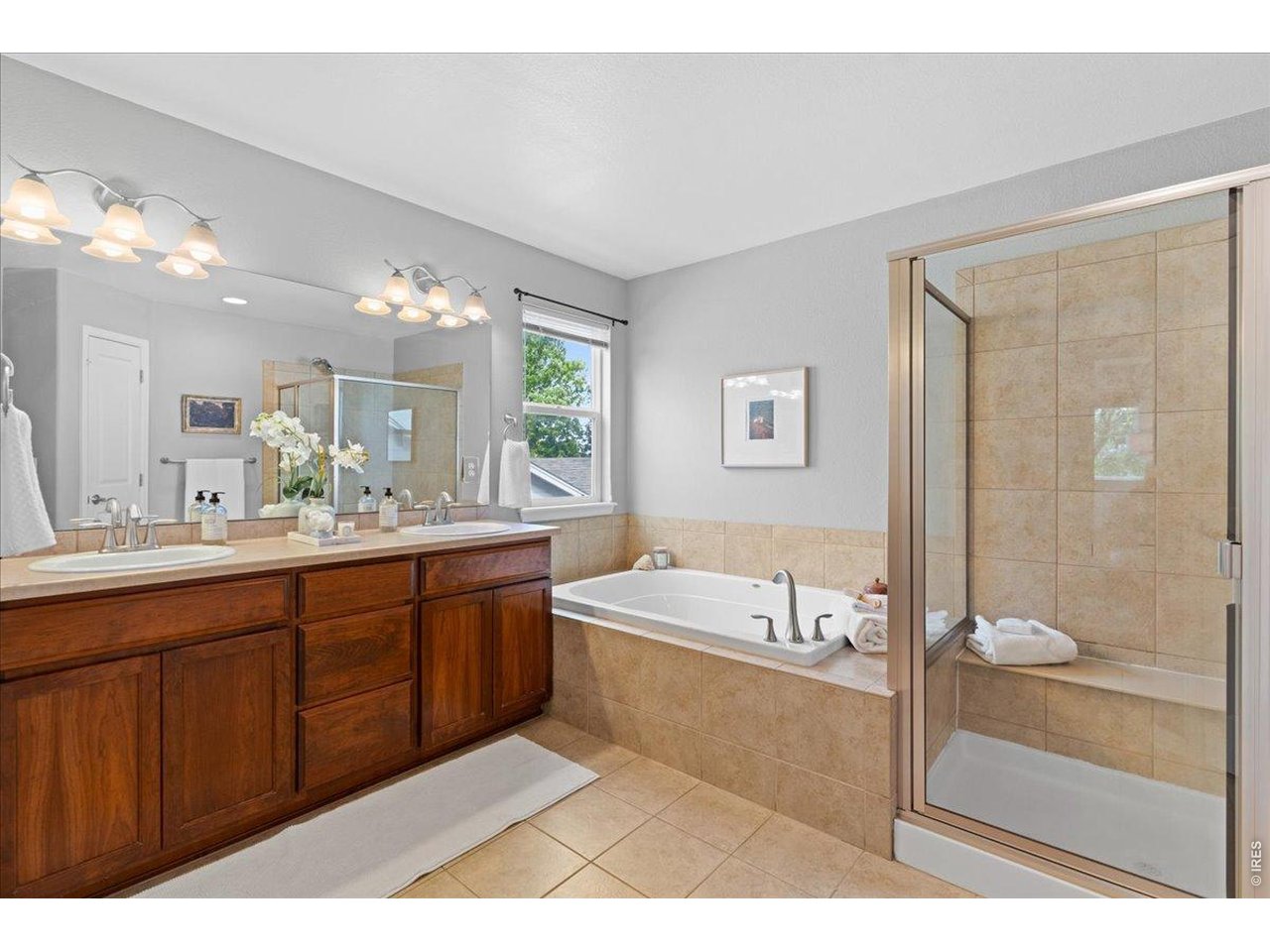 Primary full bath with both a glass shower and large tub