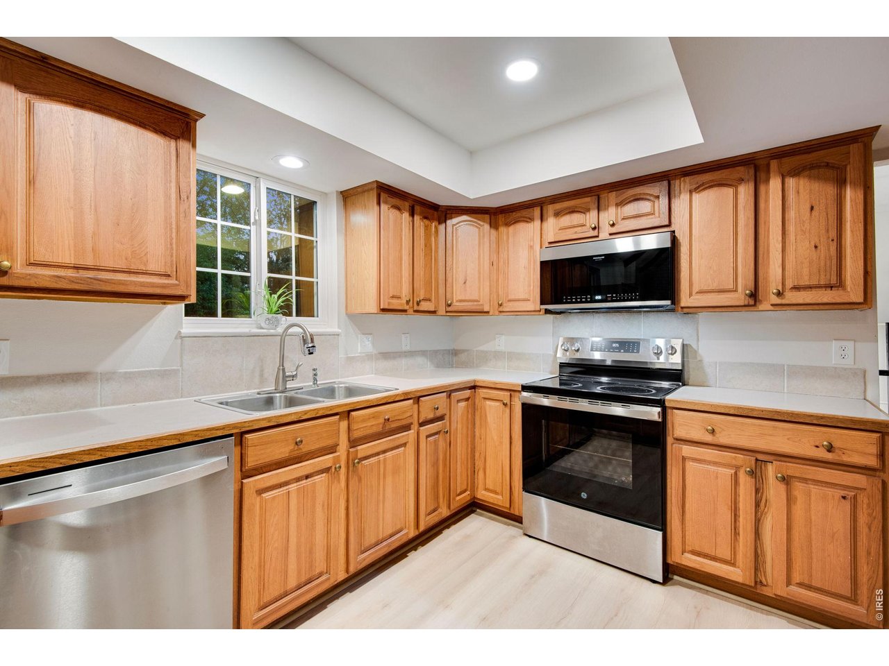 Cozy kitchen featuring plenty of Hickory cabinets with hardware and crown molding plus plenty of counter-space, pantry and all stainless-steel appliances which are included
