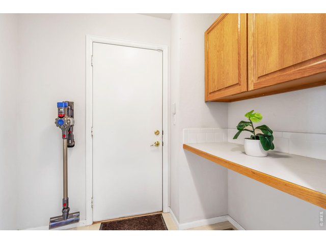 Property Photo 22 Laundry Room/Mud Room off of Garage with Storage and Counter Space