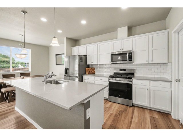 Property Photo 10 Beautiful White Kitchen with Large Center Island