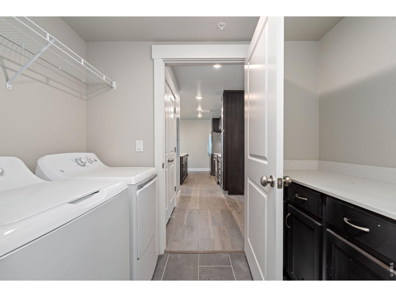 Property Photo 10 Laundry room with washer, dryer and built in cabinets w/ quartz countertops. 