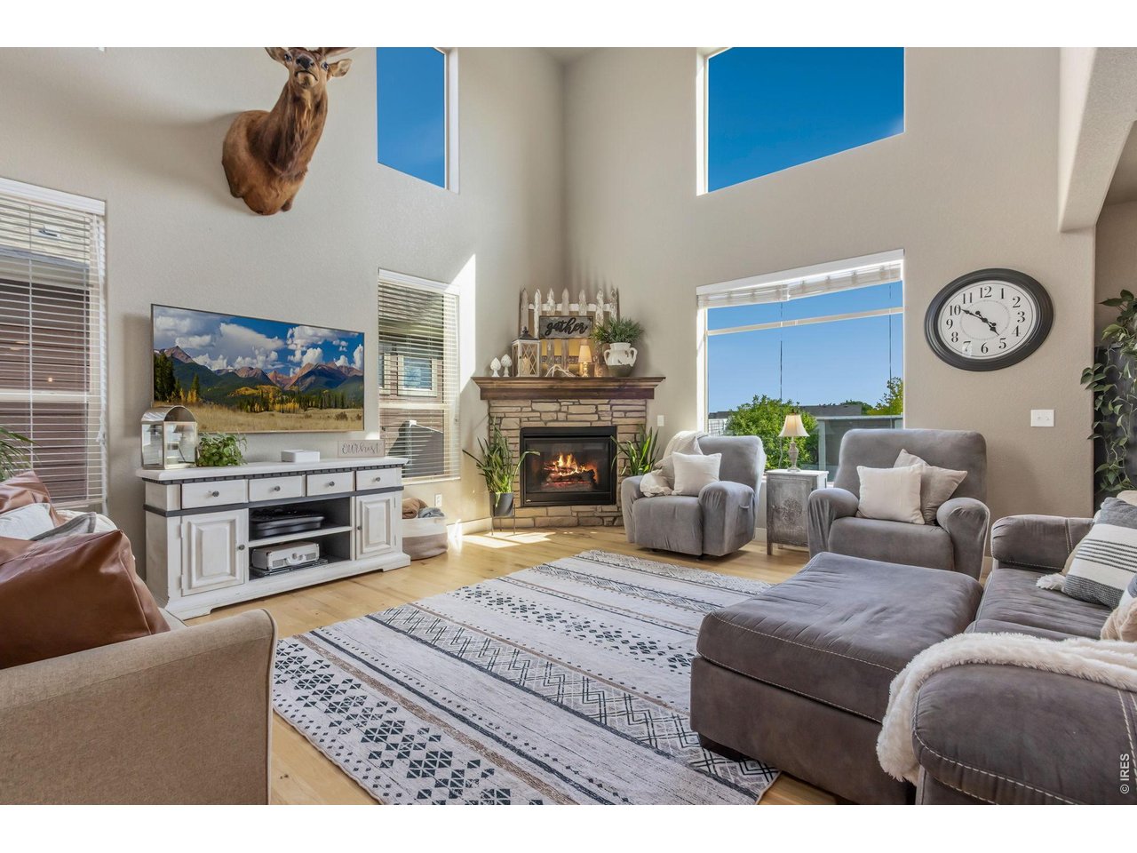 Property Photo 1 Step inside to soaring ceilings and rich hickory hardwood flooring.