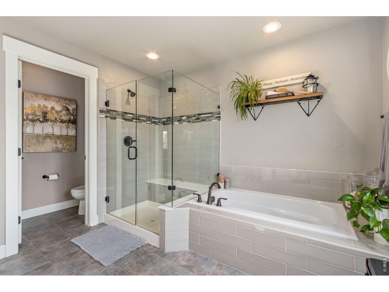 Property Photo 26 Large walk-in shower featuring built-in bench seating.