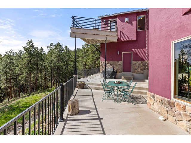 Property Photo 32 Back of Home with Patio and Balconies