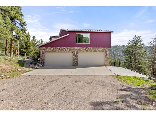 Property Photo 33 Large 4 Car Attached Garage with Additional Concrete Parking Pad