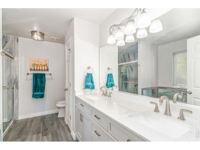 Property Photo 12 5 piece en suite is newly renovated with updated lighting, granite counters, dual sinks, LVP flooring, walk in shower a large soaking tub. 