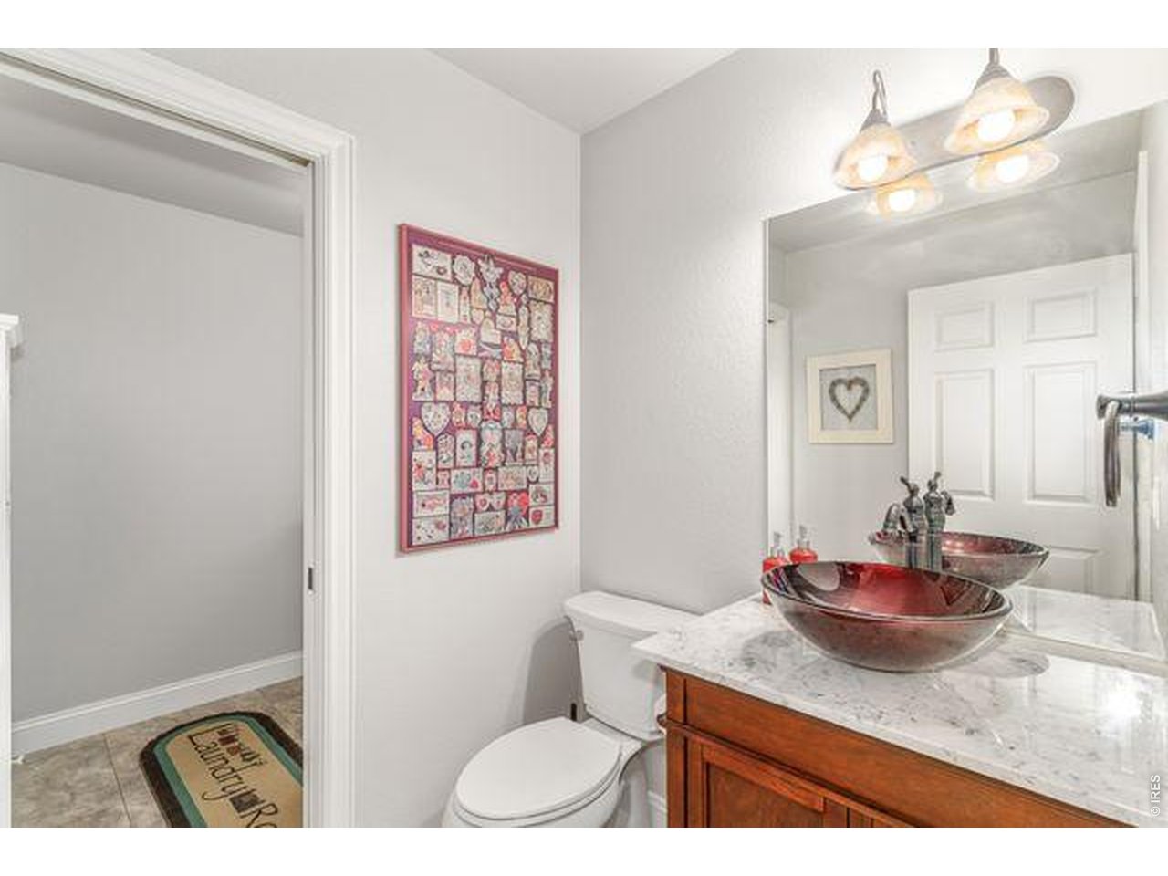 Powder room with bowl sink of laundry, garage, and kitchen.