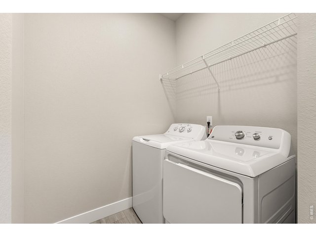 Property Photo 14 Laundry room with washer, dryer and built in shelving. 