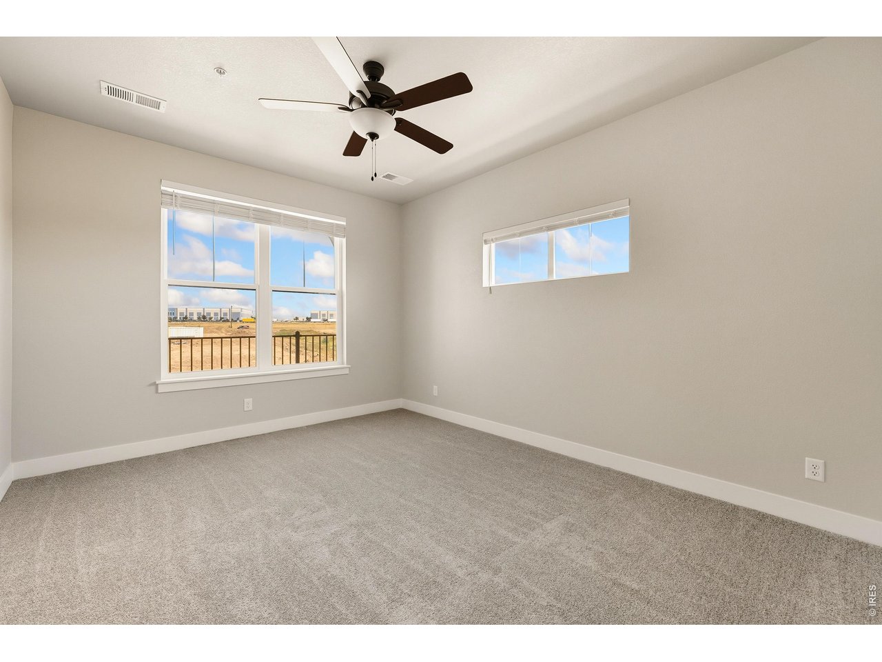 Property Photo 8 Primary bedroom w/ ceiling fan included. 
