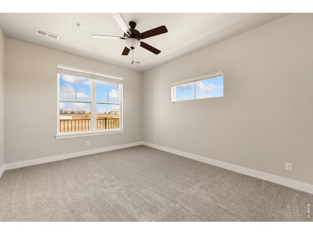 Property Photo 8 Primary bedroom w/ ceiling fan included. 
