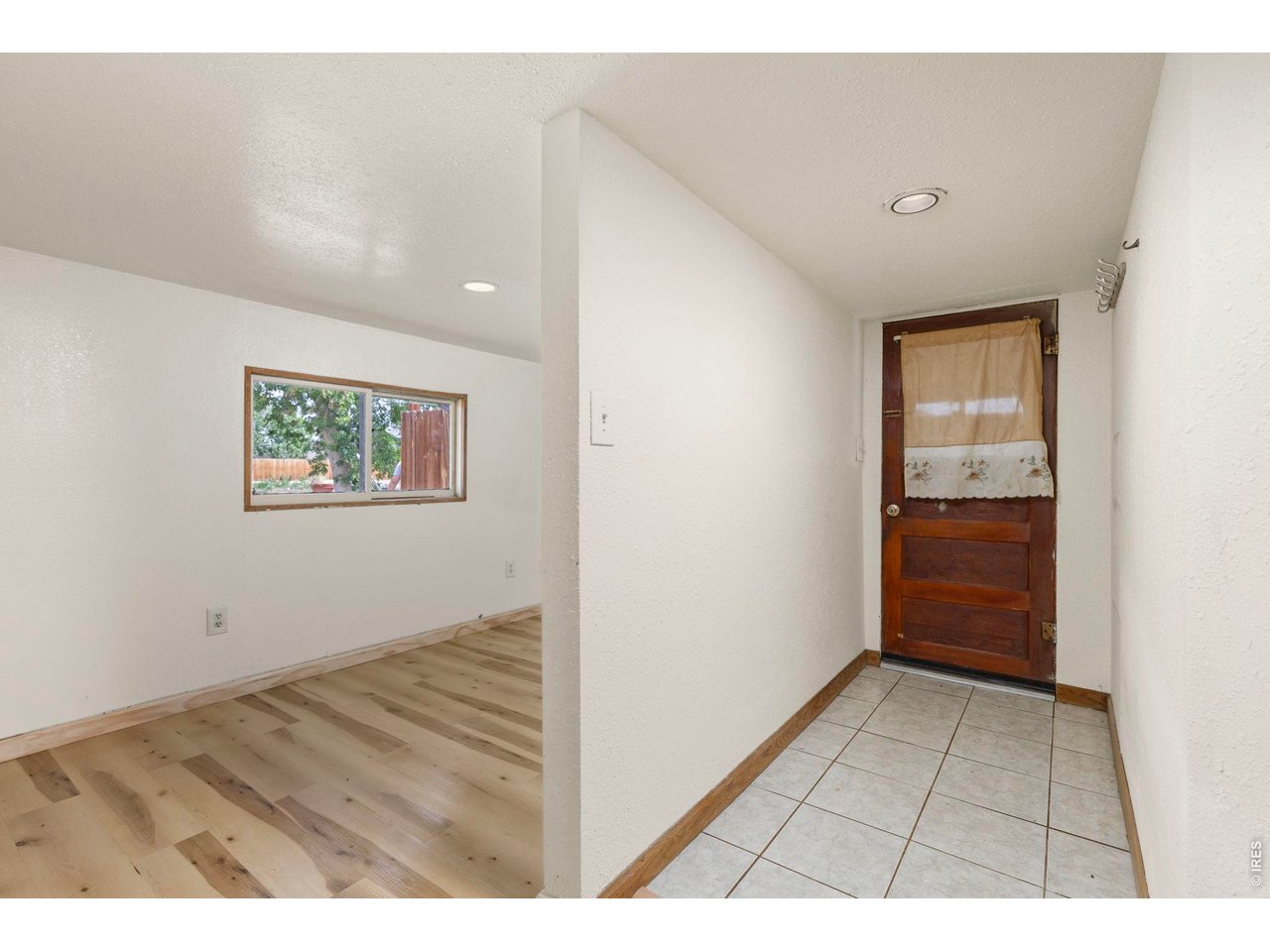 Front entry, with tile floors. To the left is the bedroom