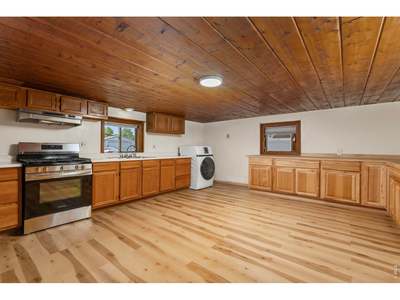 Kitchen area with gas stove and unused oven. Only one year old. Along with a clothes washer/dryer combo, one year old.