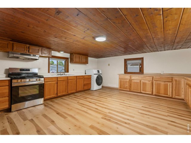 Property Photo 7 Kitchen area with gas stove and unused oven. Only one year old. Along with a clothes washer/dryer combo, one year old.
