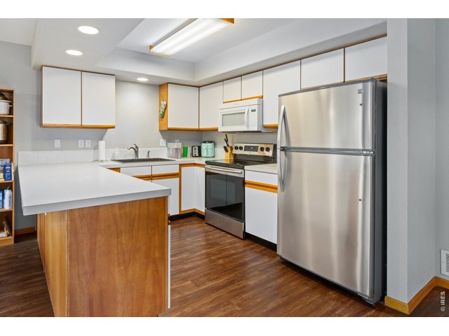 Property Photo 6 Kitchen with stainless appliances.