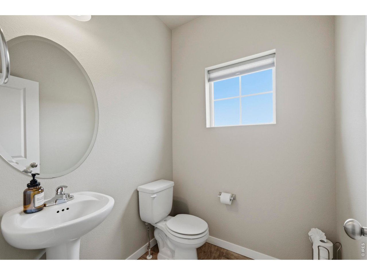 Main level powder room is bright and inviting.