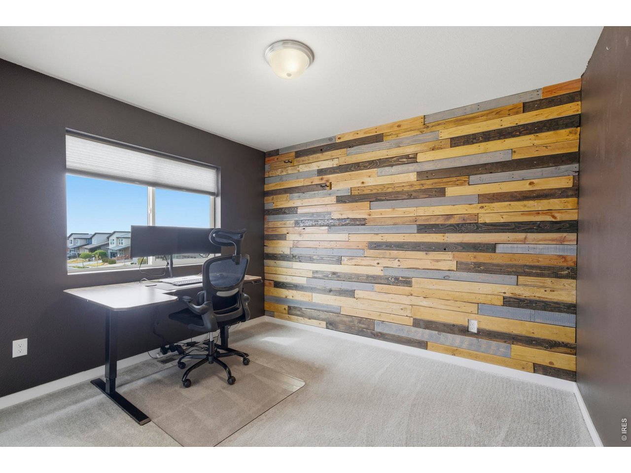 Third bedroom has been accented with a shiplap wall, and creates a great office space with mountain views from the window.