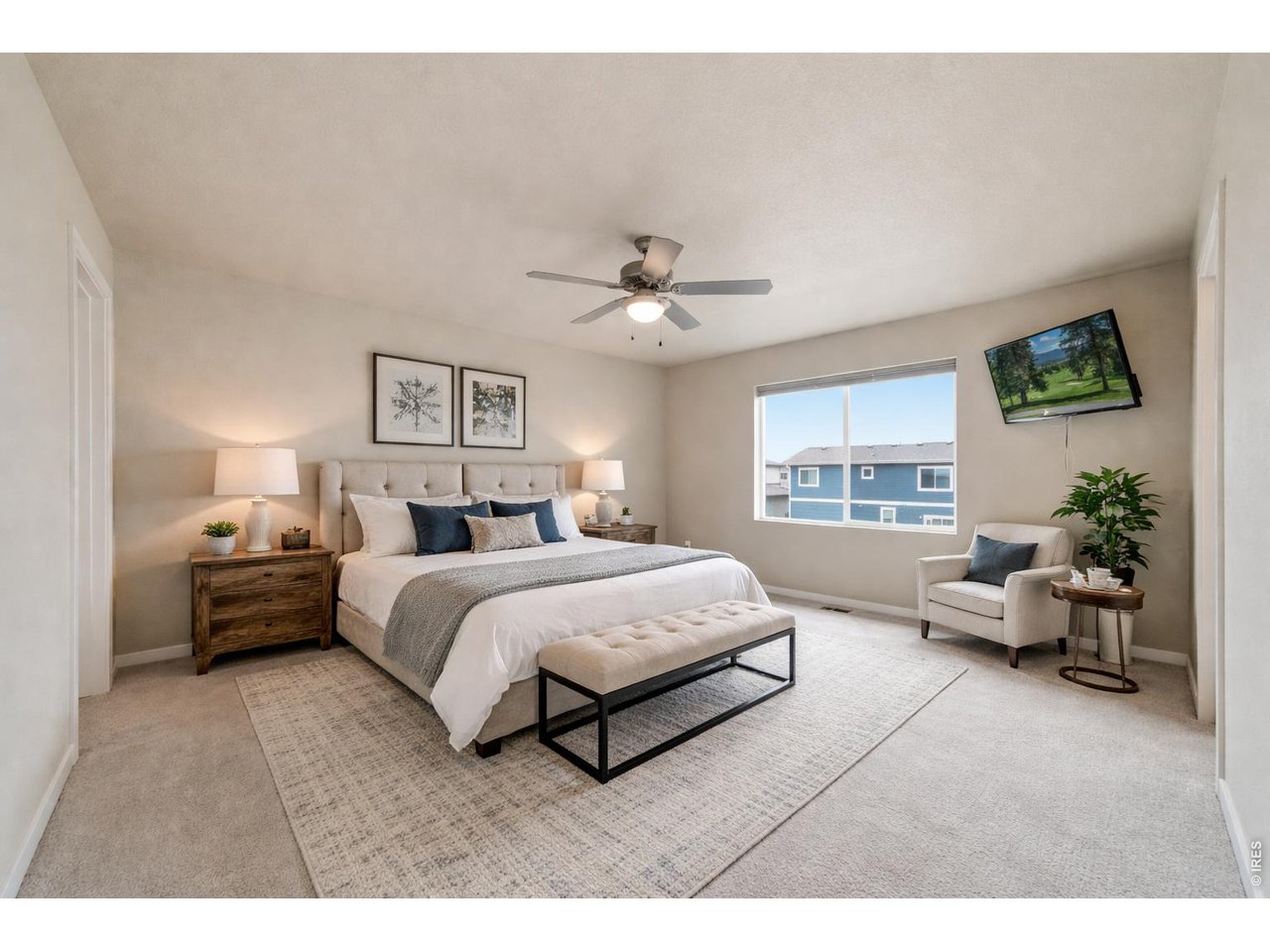 Large primary bedroom is a great end-of-the-day retreat. ***Photo staged with AI***