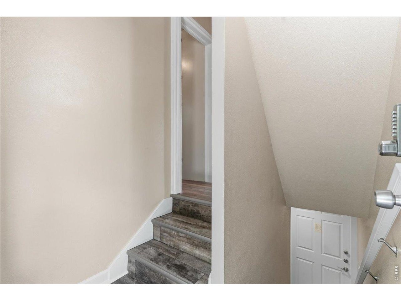 Stairs to upstairs unit laundry and storage space