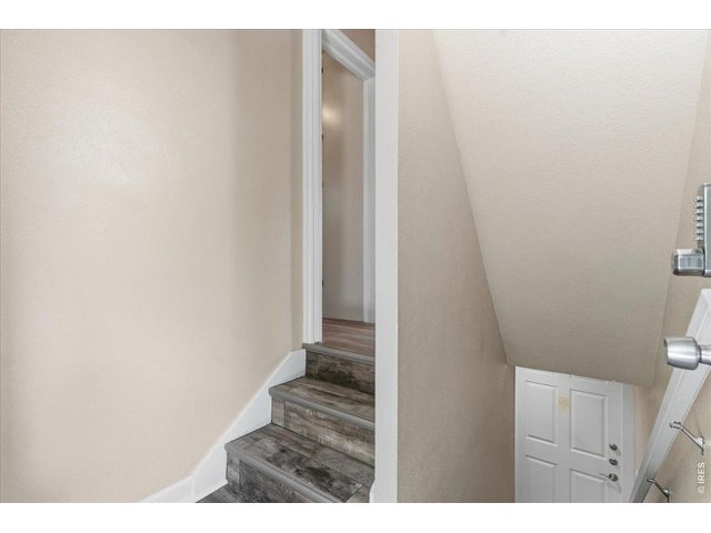 Property Photo 17 Stairs to upstairs unit laundry and storage space