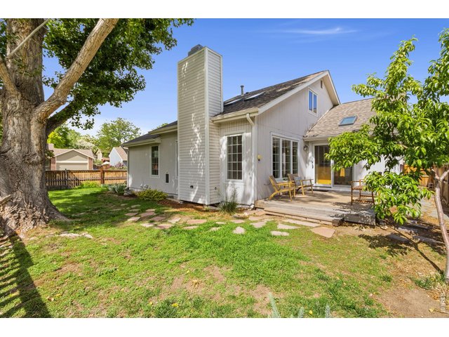Property Photo 28 Deck and great landscaping on this fully fenced corner lot backing to open space. Producing peach tree included!