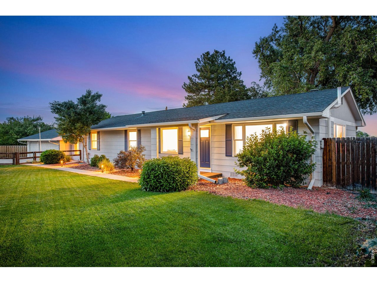 Front yard is irrigated and features mature landscaping, large berm and privacy fence for privacy and noise control 