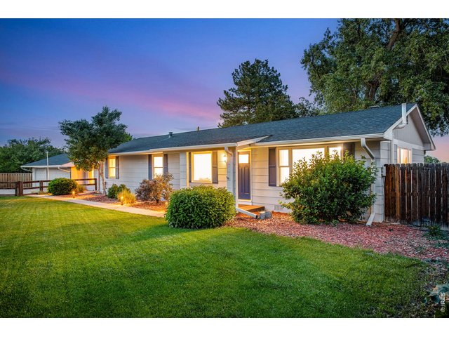 Property Photo 5 Front yard is irrigated and features mature landscaping, large berm and privacy fence for privacy and noise control 