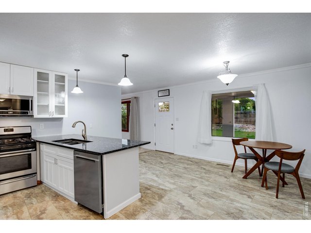 Property Photo 11 Granite slab countertops with a breakfast bar 