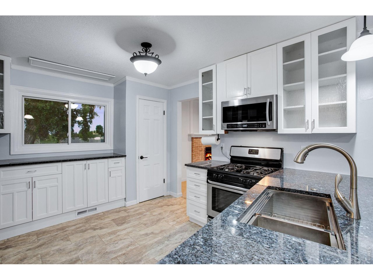 Cozy Kitchen features a pantry and plenty of cabinets and counter-space 