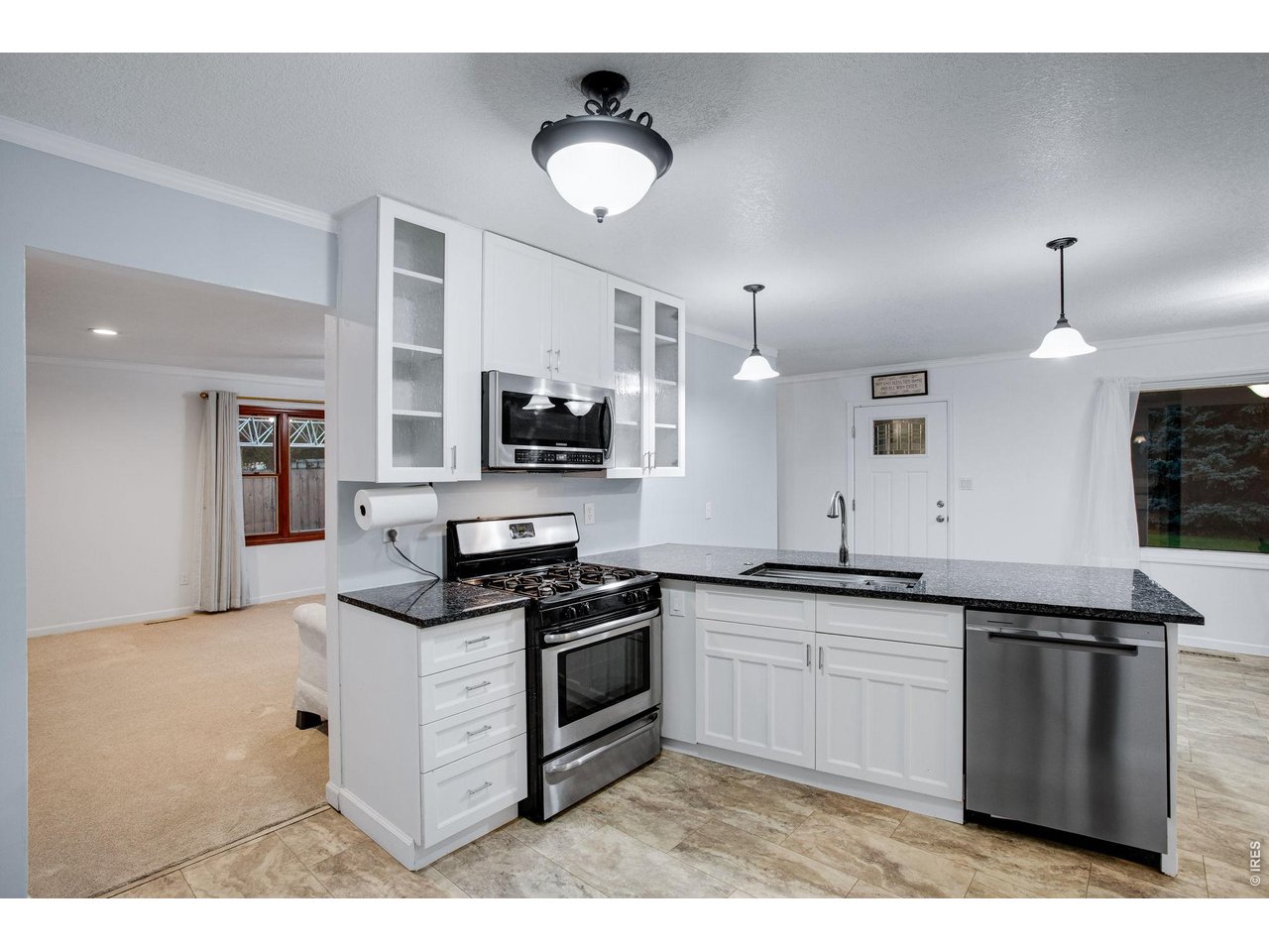 Kitchen opens up to a large full length living room