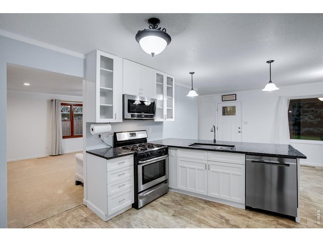 Property Photo 14 Kitchen opens up to a large full length living room